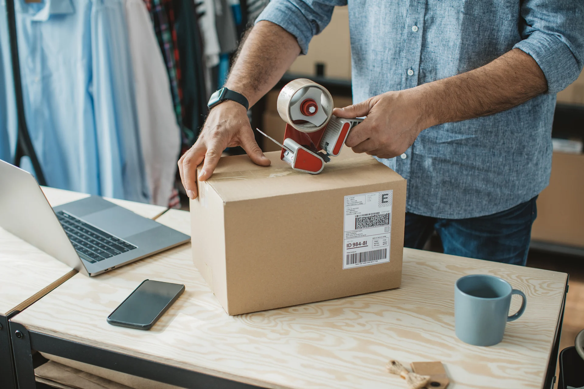 Person packing and sealing parcel