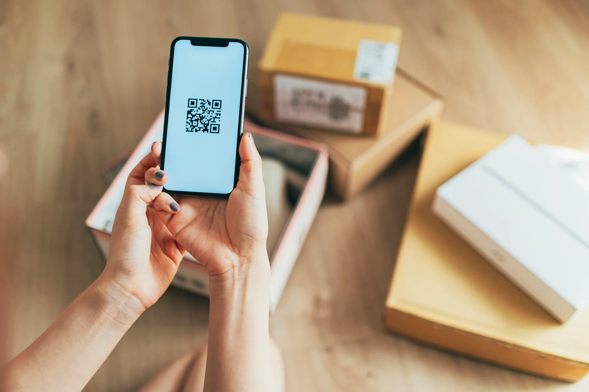 Person scanning parcel QR code with phone