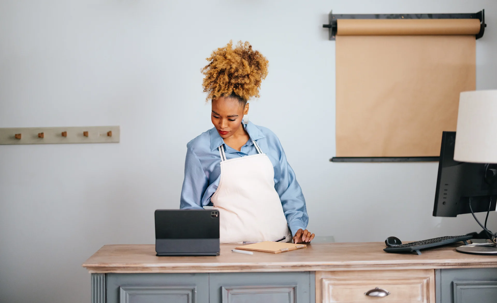woman looking at tablet with parcel