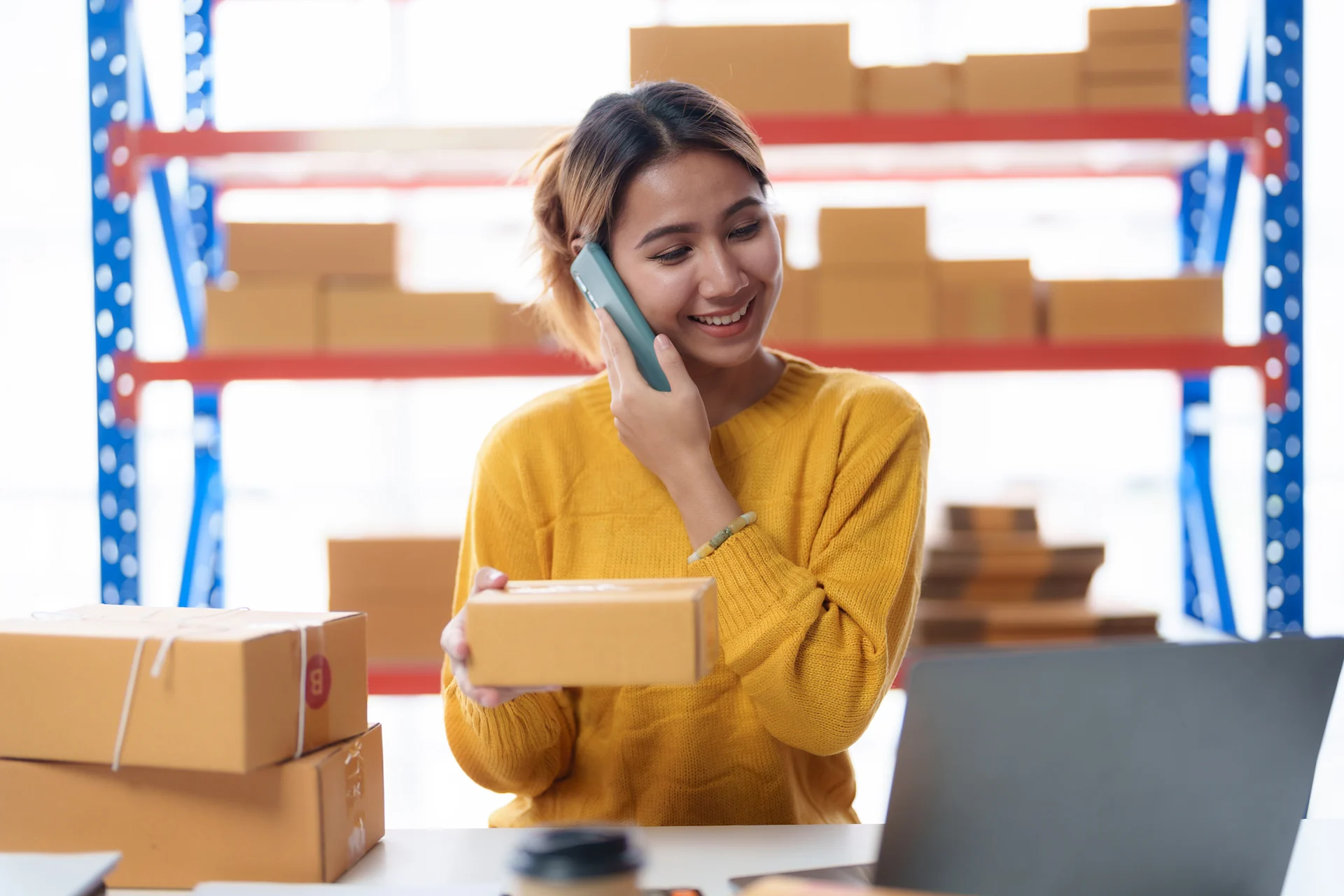 woman on the phone while holding parcel
