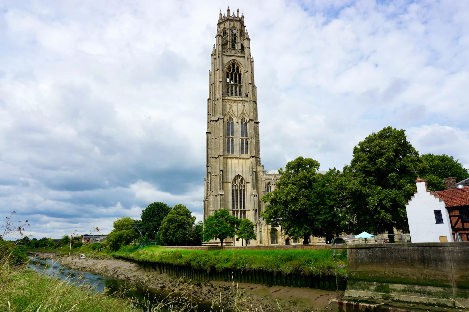 Cathedral on River Bank against Blue Sky