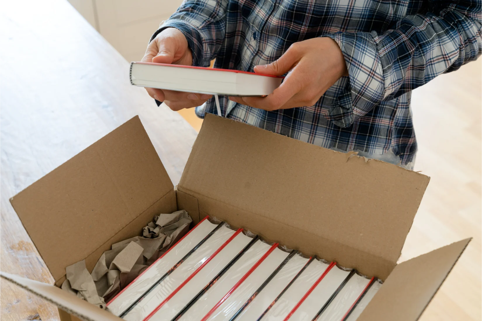 Person taking a book out of box
