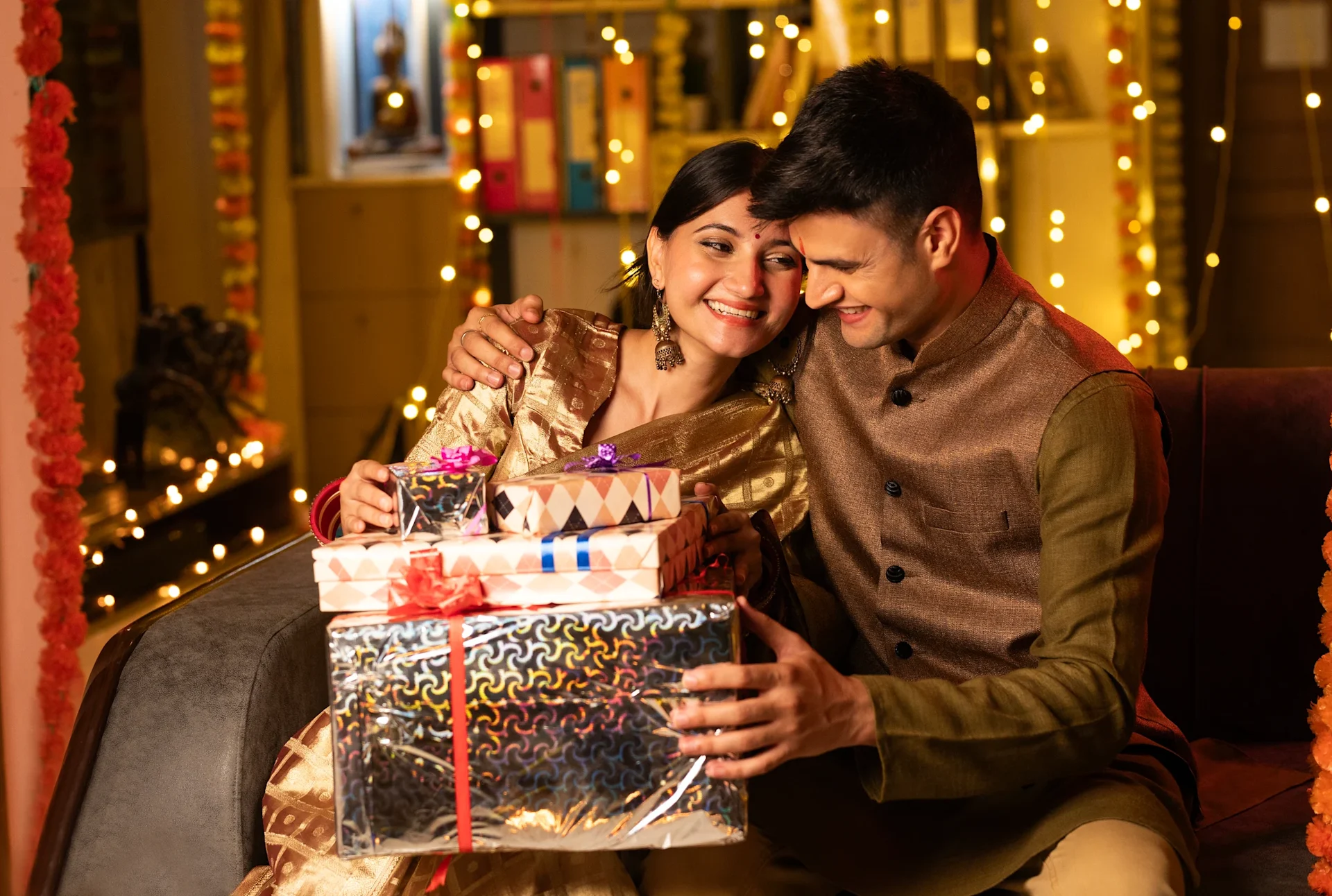 Couple holding gift parcels for Diwali celebration