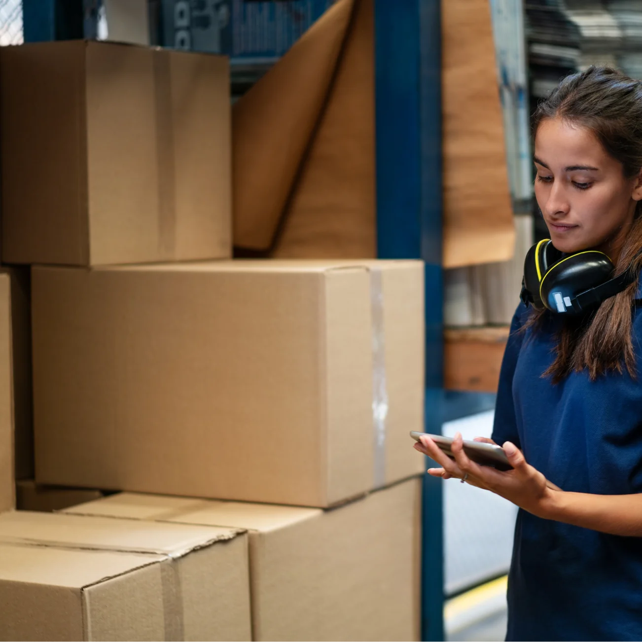 Warehouse worker checking stack of parcels