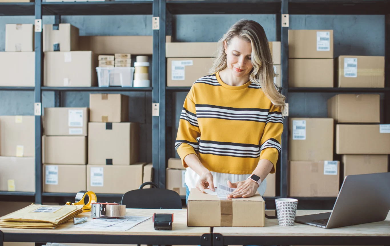 Woman in warehouse in front of shelves with boxes