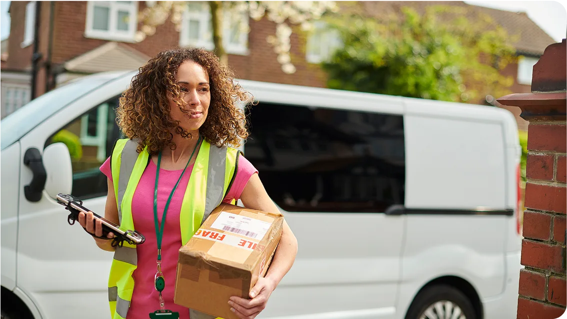 Parcel delivery woman approaching a house.