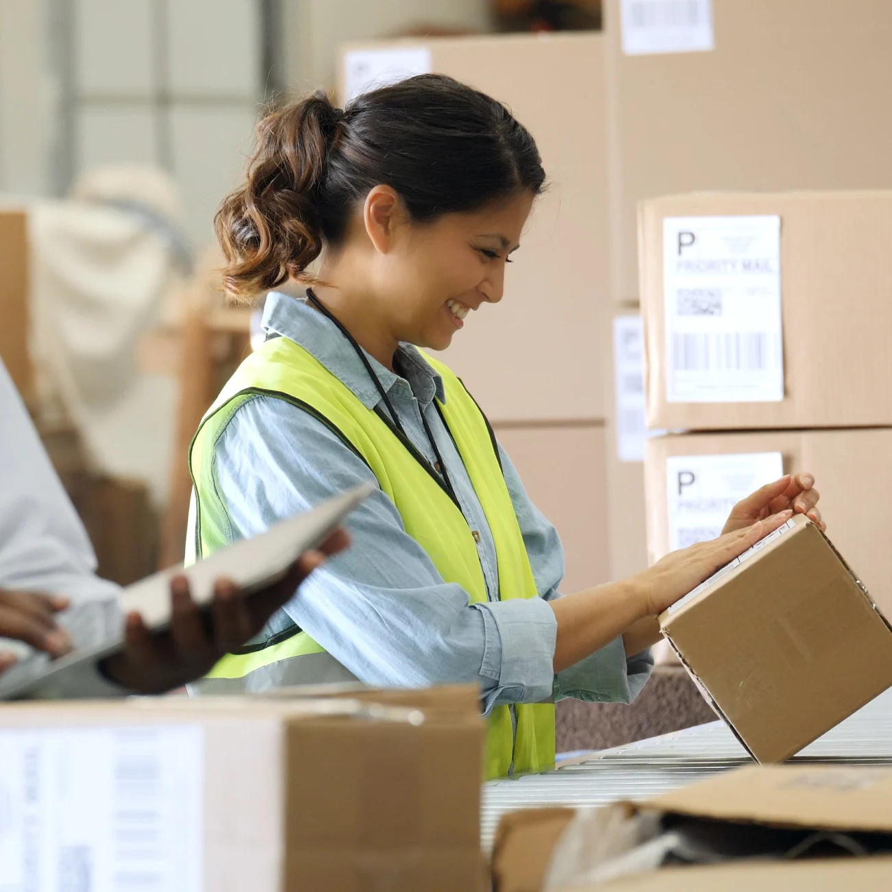 person smiling while signing parcel